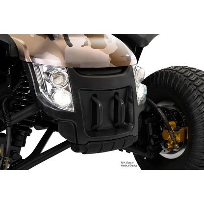 Close-up of the Pride Baja® Wrangler® 2 Heavy Duty Outdoor Scooter with Canopy in camo, showing headlights, suspension, black bumper with two handles, and a large rugged tire featuring visible gold brake components.
