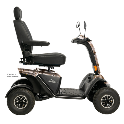 The Pride Baja® Wrangler® 2 Heavy Duty Outdoor Scooter with Canopy is a four-wheeled, all-terrain mobility scooter featuring a high-backed seat, armrests, mirrors, rugged tires, and a black design with tan accents for comfort and versatility.