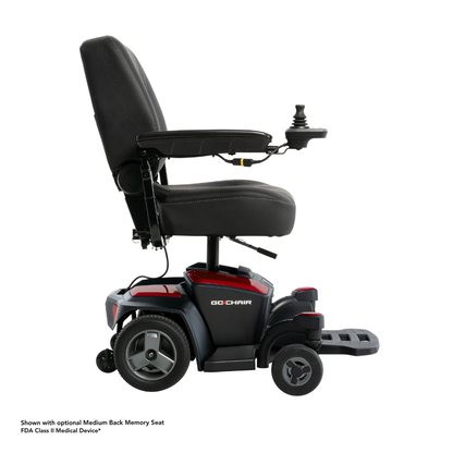 The Pride Mobility Go Chair® Portable Powerchair, shown in black and red with padded seat, armrests, footrest, large rear wheels, and a joystick controller, is displayed in side view. It offers a compact turning radius for easy maneuverability.