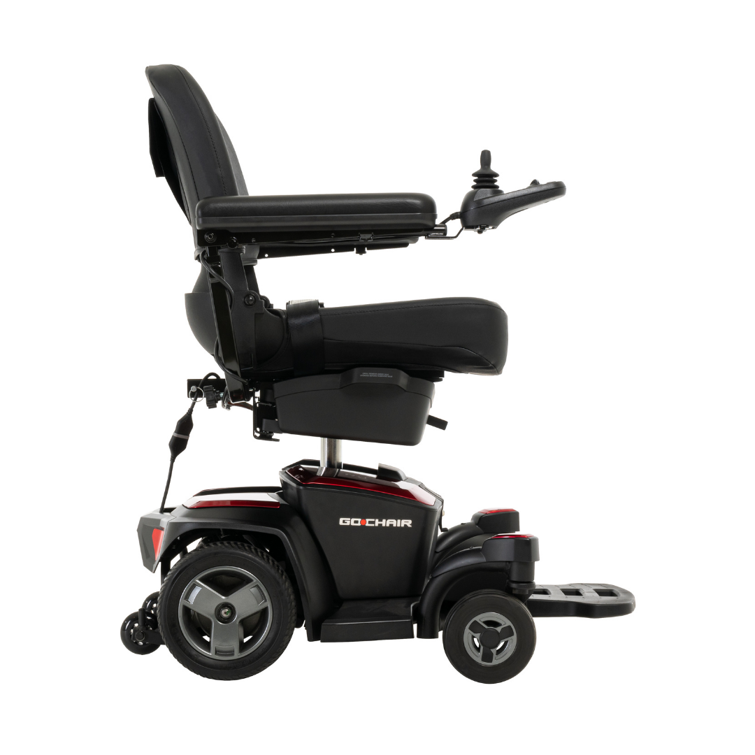 A side view of the Pride Mobility Go Chair® Portable Powerchair in black and red, featuring a padded seat, backrest, armrests, joystick control, and footrest on a white background.
