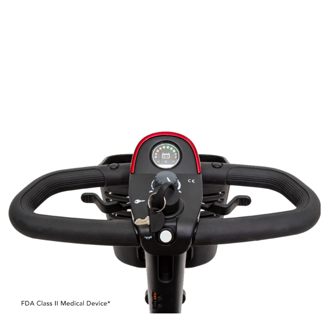 Close-up of the Pride Go Go® Sport 3-Wheel Scooter showing its customizable handlebars and dashboard. It features a speedometer, ignition key with a key inserted, two handgrips, and FDA Class II Medical Device* text in the lower left corner.