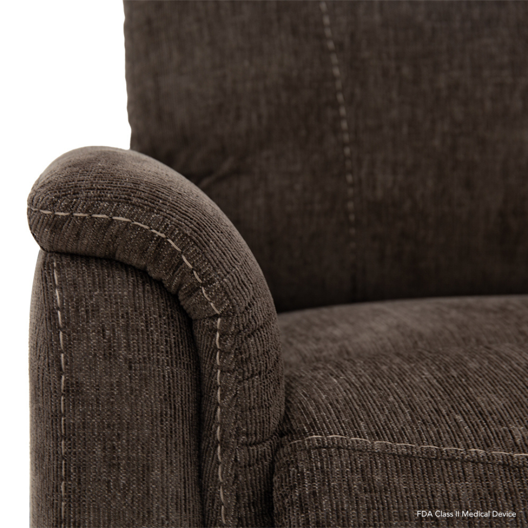 Close-up product description of the Pride Mobility Genesis LC150 Lift Chair Recliner, showcasing brown upholstery, curved armrest, textured fabric, visible stitching detail, and quality craftsmanship. See spec-table for full specs.