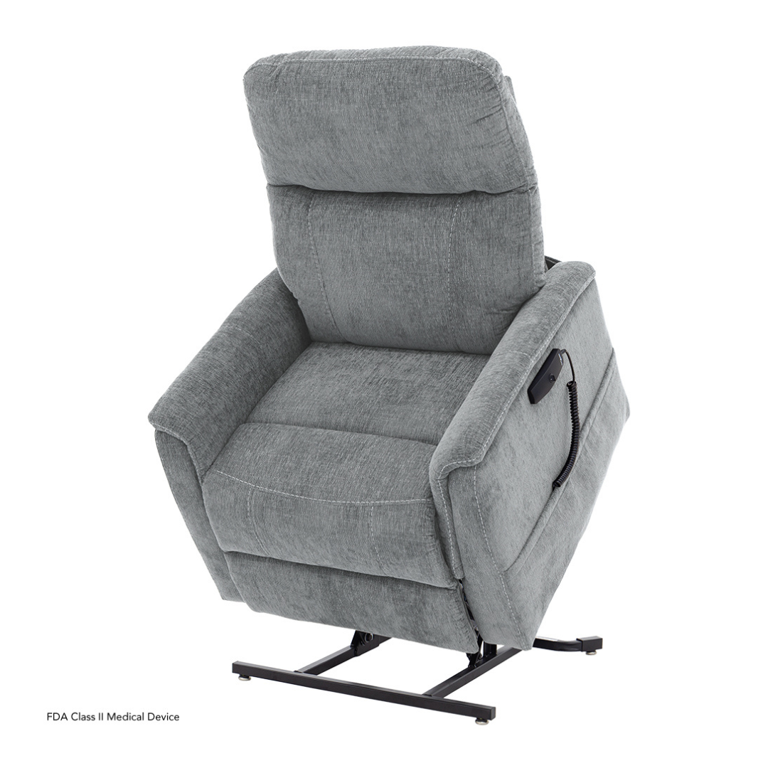 The Pride Mobility Genesis LC150 Lift Chair Recliner, shown slightly tilted forward, demonstrates its stand-assist feature. A remote control is attached to the right armrest by a cord. See product description for full specs.