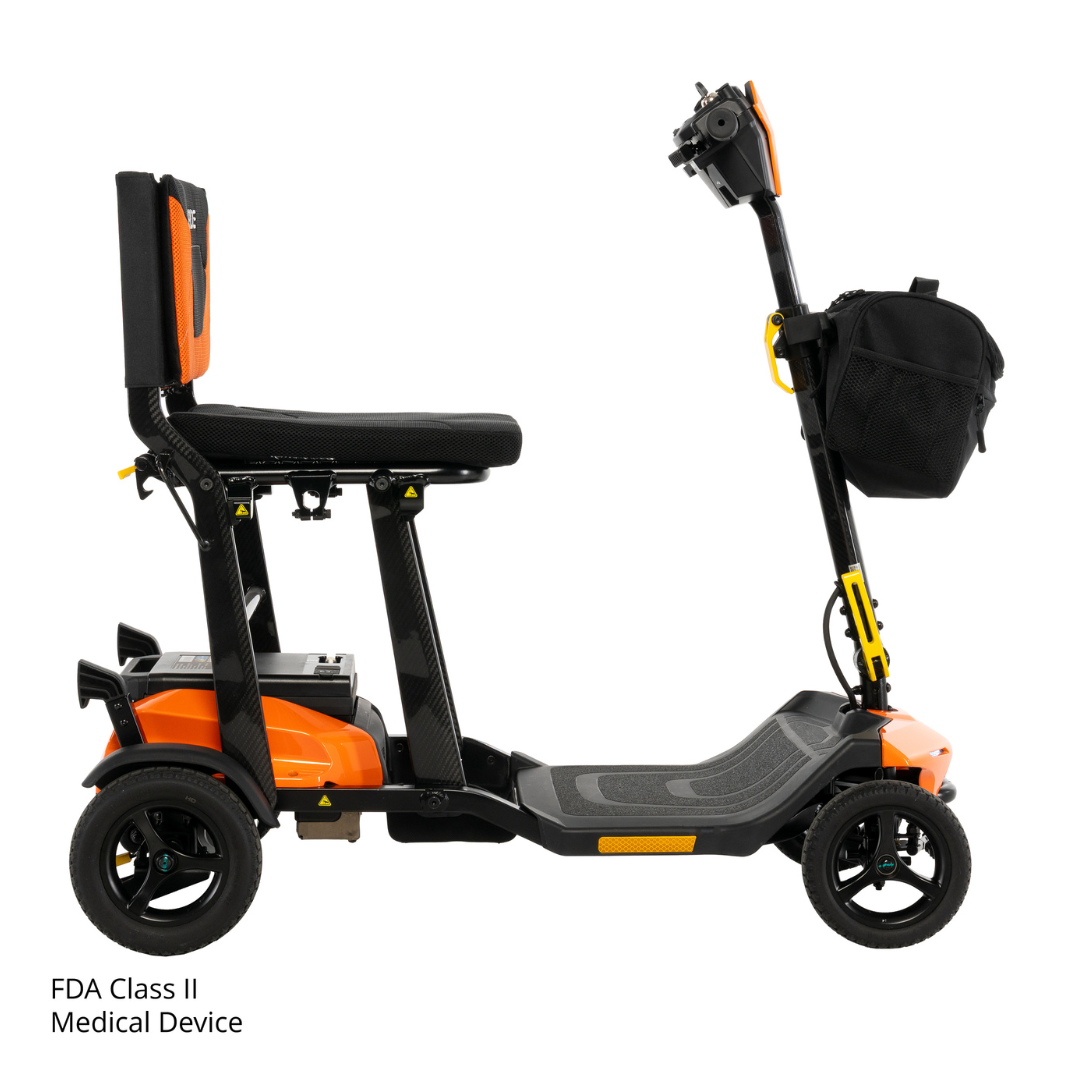 The Pride Mobility Go Go® Super Portable Mobility Scooter features an orange and black design with a seat, backrest, handlebar, and front black storage bag. “FDA Class II Medical Device” is displayed in the bottom left corner.