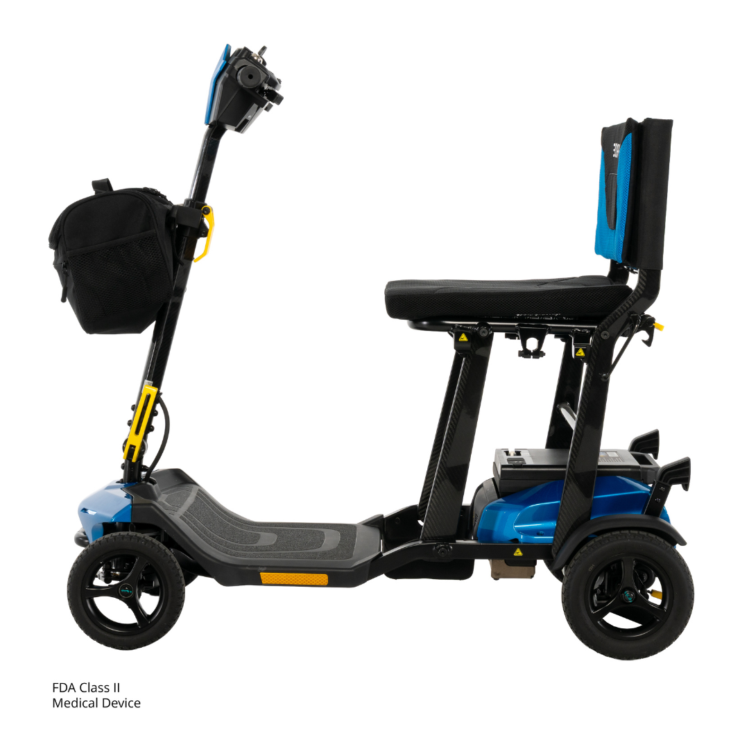 The Pride Mobility Go Go® Super Portable Mobility Scooter is a compact blue and black three-wheel scooter featuring a padded seat with backrest, front storage bag, lightweight design, and an FDA Class II Medical Device label near the footrest.