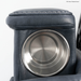 Close-up of a stainless steel cup holder in the armrest of the Pride VivaLift Ultra PLR4955 Recliner with Lift Assist, Heat and Massage. White stitching accents the dark gray leather, highlighting its premium comfort and style.