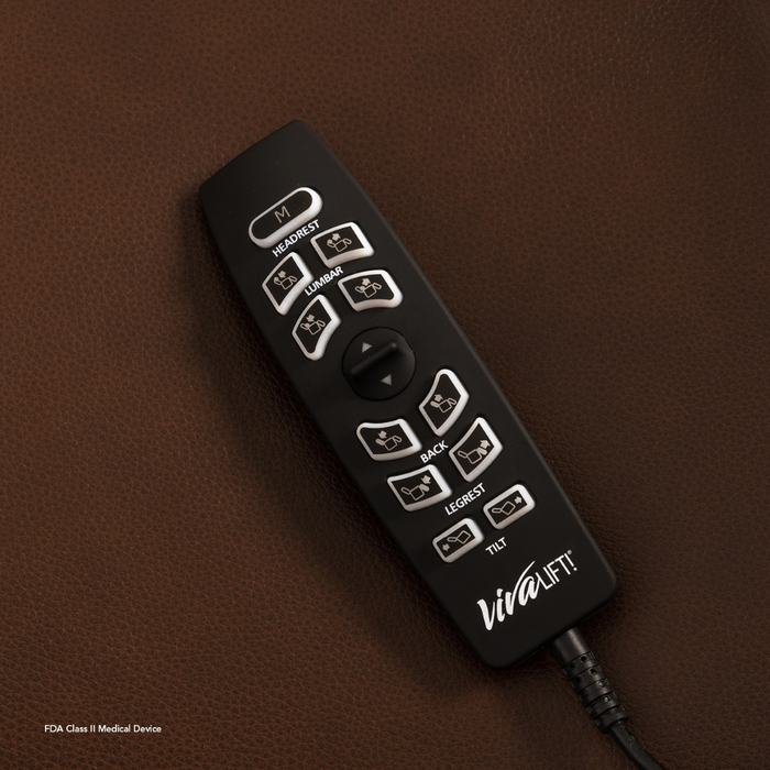 A black remote with white buttons for adjusting the Pride VivaLift Ultra PLR4955 Recliner with Lift Assist, Heat and Massage (headrest, lumbar, back, legrest) lies on brown leather. The VivaLift! brand name is visible.
