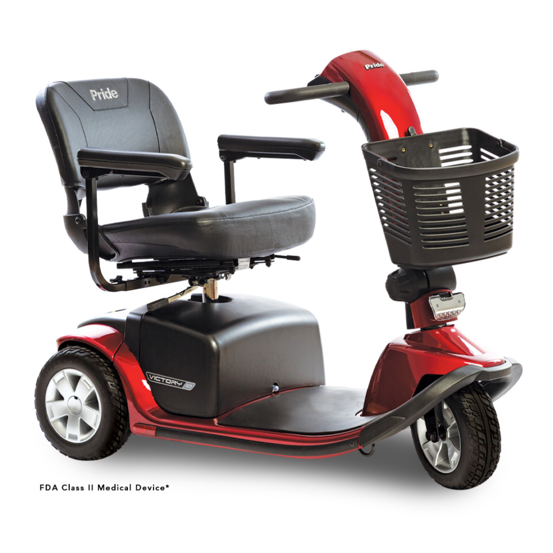 The Pride Mobility Victory® 10 Bariatric 3-Wheel Scooter, featuring a red and black design with a black seat, armrests, and a front basket, is displayed on a white background.