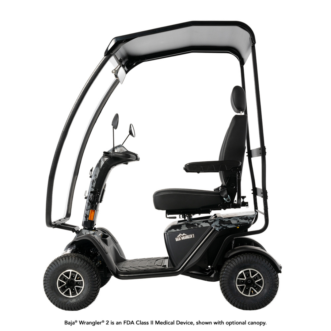 The Pride Baja® Wrangler® 2 Heavy Duty Outdoor Scooter with Canopy is a four-wheel black mobility scooter with a seat, armrests, and raised canopy. It’s an FDA Class II medical device; canopy shown is optional.