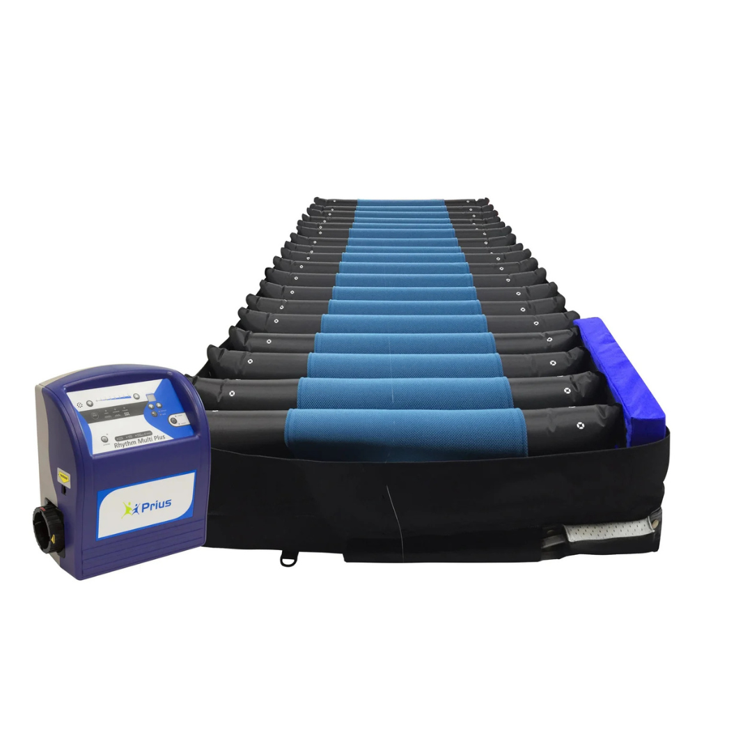 The Prius Rhythm Multi Plus Bariatric Pressure Redistribution Mattress, featuring blue air chambers and an integrated digital control unit, is displayed on a white background; it is engineered to deliver advanced pressure redistribution for superior comfort and care.