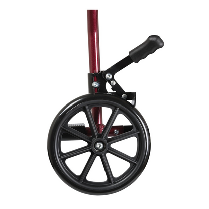 Close-up of a black wheel with spokes on the metallic red frame of the ProBasics Aluminum Lightweight Transport Chair, featuring a black hand brake lever above the wheel against a white background.