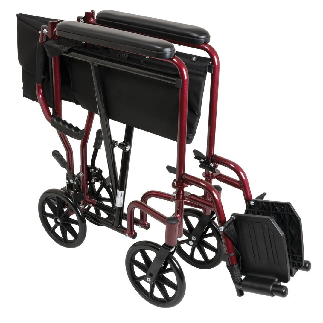 The ProBasics Aluminum Lightweight Transport Chair features a compact red frame with black seat, armrests, and footrests, and stands on four small wheels.
