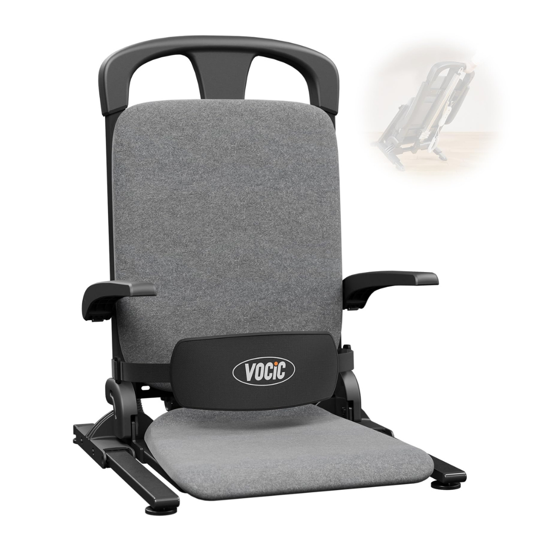 A padded, gray Pro Sit-to-Stand Portable Bariatric Patient Lift Chair | VOCIC AX15 features a high back, armrests, and sturdy black frame. The VOCIC logo is displayed on the lumbar support. Inspired by the comfort of a Floor Lift Chair, this design supports extended lounging or gaming sessions. A small inset shows the chair partially folded for storage.