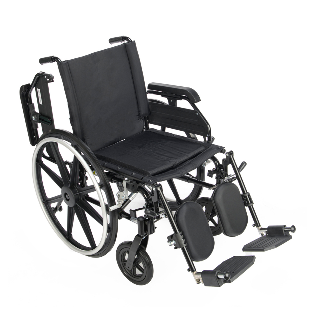 A Proactive Chariot IV XTC Wheelchair with Adjustable Seat Depth, featuring large rear wheels, small front wheels, adjustable footrests, padded leg supports, and a black frame, is displayed against a white background.