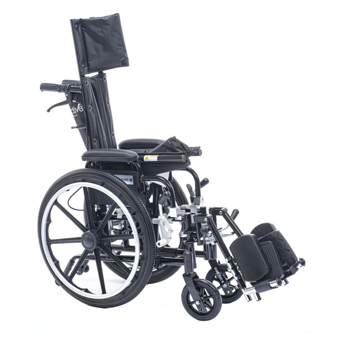 The Proactive Chariot IV XTC-RC Pediatric Folding Reclining Wheelchair, shown at an angle against a white background, features a black carbon steel frame, manual operation, elevated leg rests, padded calf supports, large rear wheels, and small front casters.