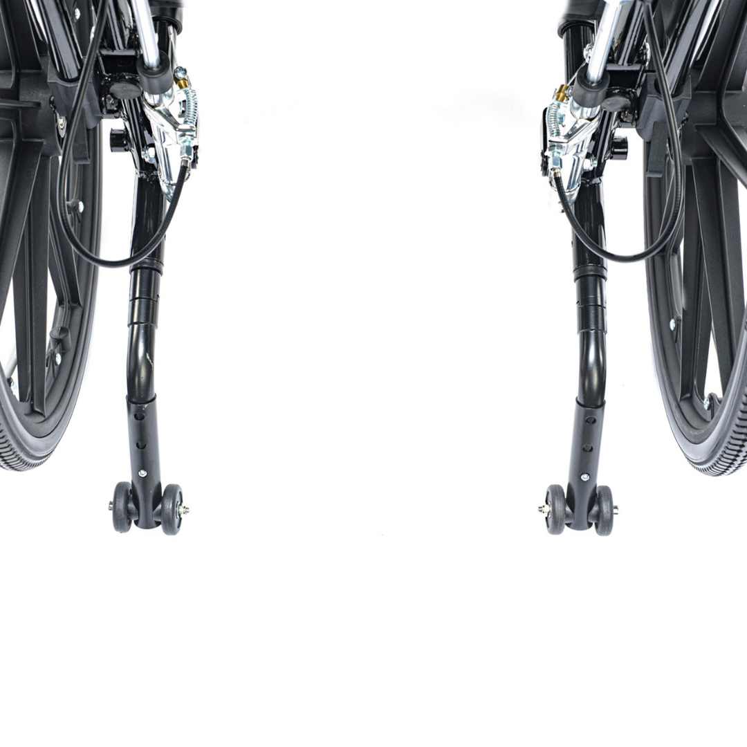 Close-up of the Proactive Chariot IV XTC-RC Pediatric Folding Reclining Wheelchair's lower rear, showing its black carbon steel frame, wheels, and small rear anti-tip wheels against a white background.