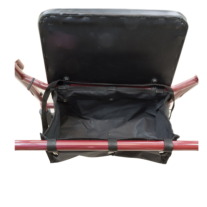 A close-up of the storage pouch beneath the padded seat of the ProBasics Lightweight Steel Portable KD Rollator shows an empty black fabric compartment securely fastened to the frame.