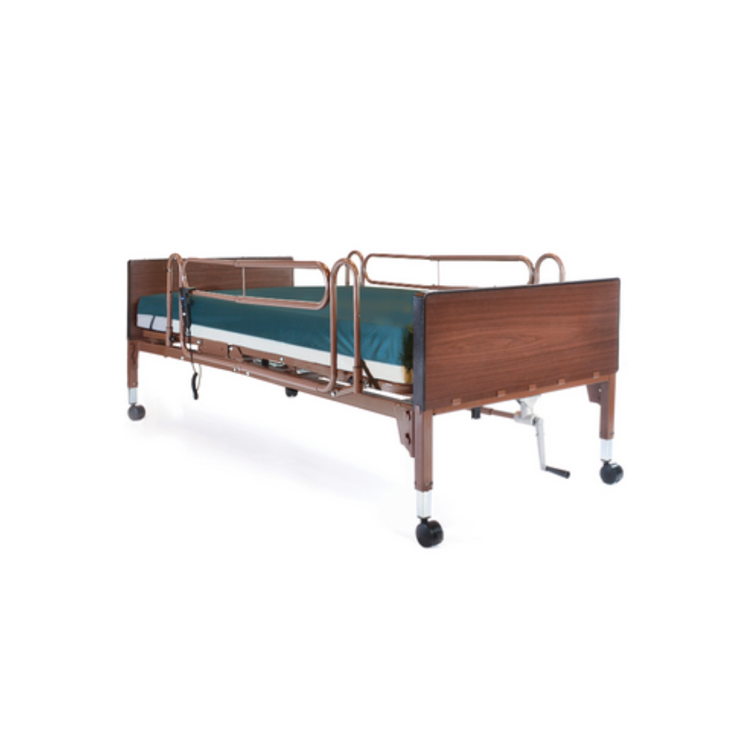 A hospital bed with wooden headboard and footboard, ProBasics Reduced Gap Full-Length Bed Rail for safety, thin green-covered mattress, and wheels on each leg, shown against a plain white background.