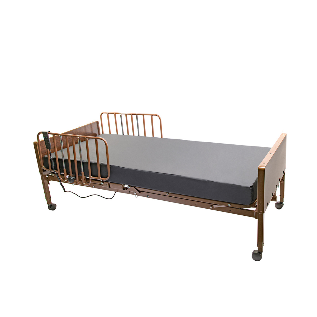 The Proactive Protekt Akra-FE™ Bariatric Full-Electric Bed, featuring a gray mattress, metal side rails, wooden head/footboards, and wheels for mobility, is designed for home care and shown against a plain white background.