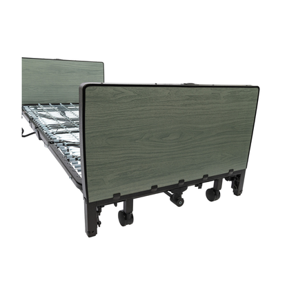 The Protekt Akra-FE™ Full-Electric Bariatric “Low” Bed features a wood-patterned headboard and footboard, a sturdy metal mattress support, and wheels for easy mobility, displayed against a white background.