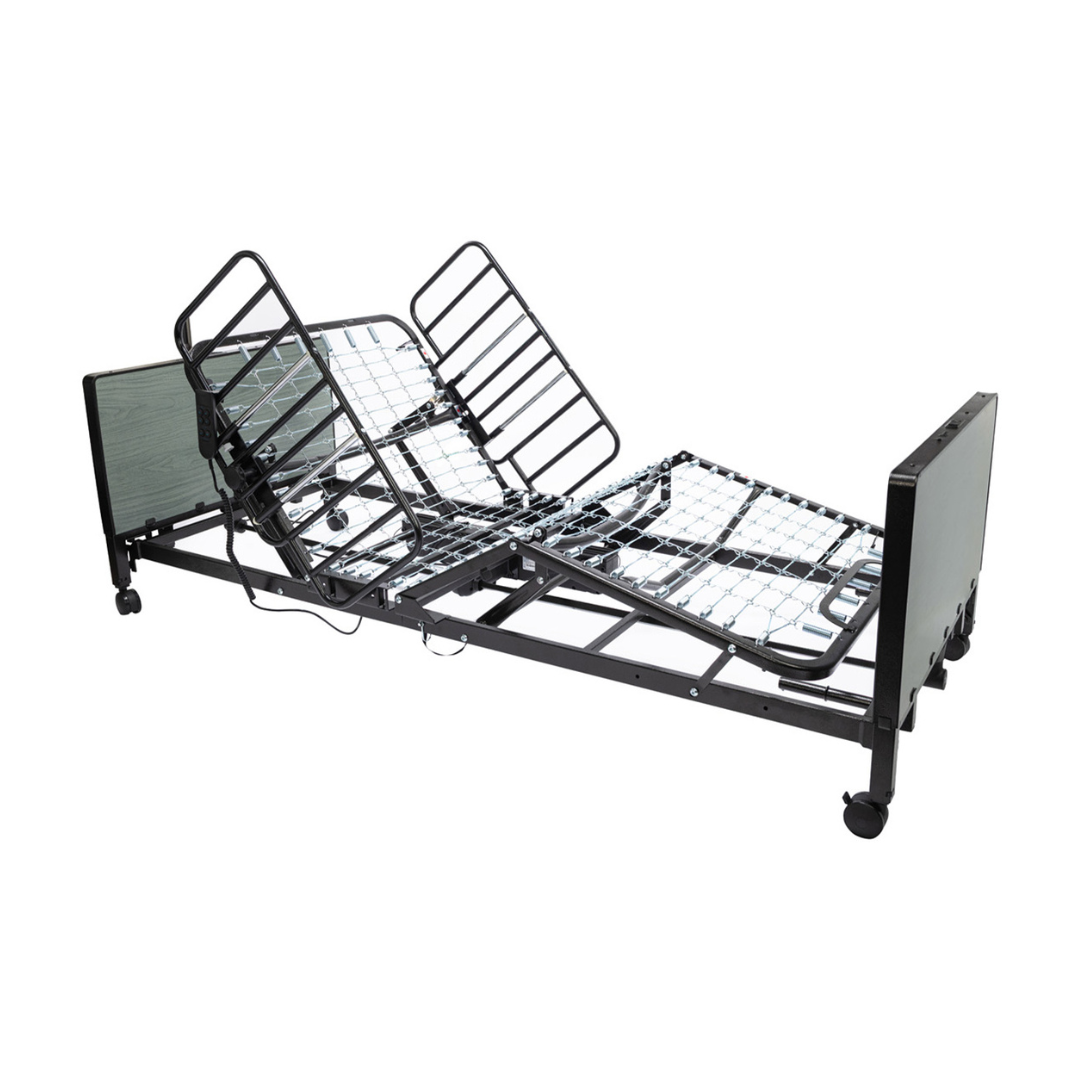 The Protekt Akra-FE™ Full-Electric Bariatric “Low” Bed is an adjustable hospital bed with metal rails and a segmented frame, featuring elevation at the head and legs and wheels for mobility, designed for use in both hospital and homecare settings.