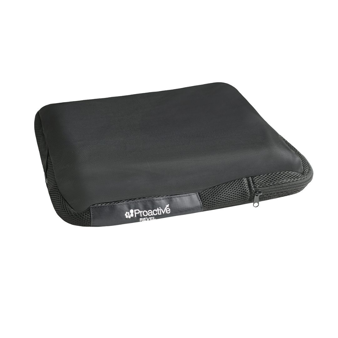The Protekt® Revel Air Cushion is a black, rectangular seat cushion featuring a zippered mesh cover and Proactive branding, designed for high performance, comfort, and support.
