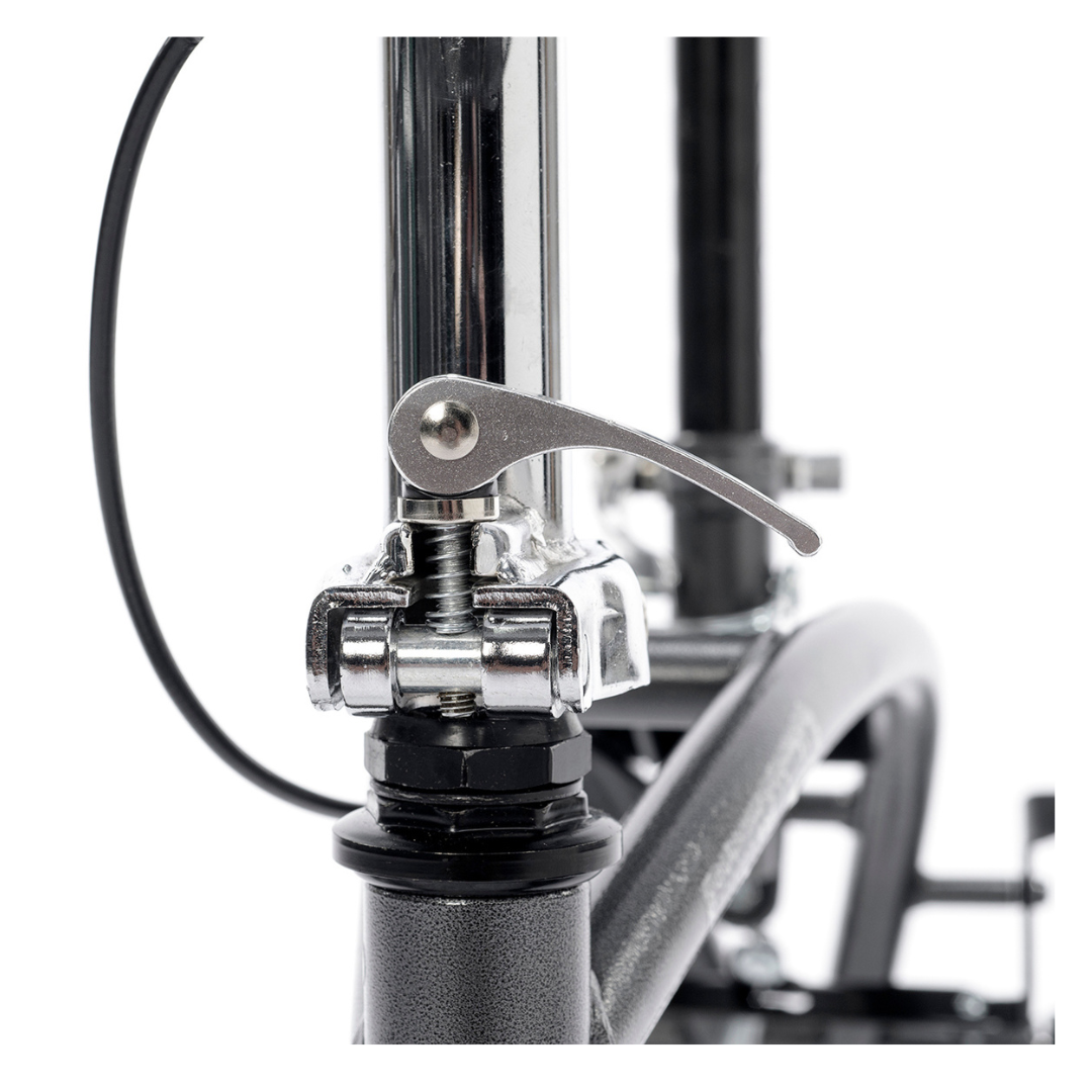 Close-up view of a bicycle’s front fork with a quick-release lever on the wheel axle, echoing the simple design of mobility aids like the Proactive Protekt® Gazelle Portable Knee Walker, with cables and bike frame parts also visible.
