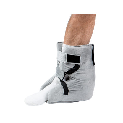 A person wears the Proactive Protekt® Heel Gel Elevation Boot with Hot or Cold Gel Pack over white socks; these boots cover the feet and lower ankles, using adjustable straps for pressure sore prevention.