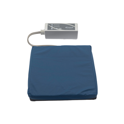 The Protekt® Seat Relief - Alternating Pressure Seat Cushion System by Proactive, featuring a blue cushion and electronic control unit, provides portable comfort and support for pressure injury prevention and relief. Shown isolated on a white background.
