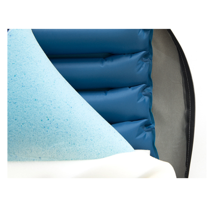 Close-up of the Protekt® Seat Relief - Alternating Pressure Seat Cushion System by Proactive: cross-section shows blue gel foam, blue air chambers, and a partially unzipped white cover revealing materials for pressure injury prevention.