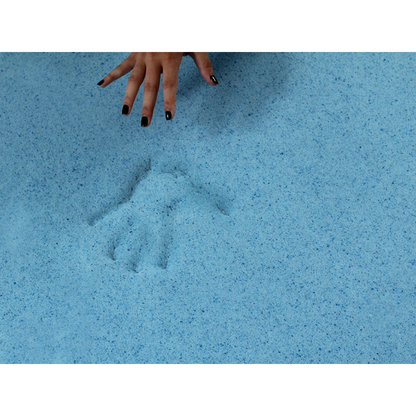A hand with black nail polish hovers above a light blue sandy surface, next to a handprint—evoking the comfort of the Protekt® Seat Relief Alternating Pressure Seat Cushion System by Proactive, designed for pressure injury prevention.