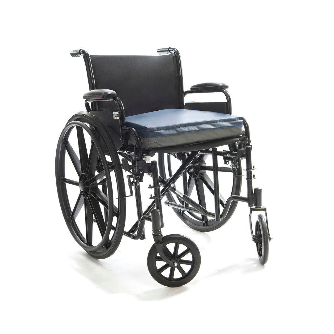 The Protekt® Seat Relief - Alternating Pressure Seat Cushion System by Proactive is shown on a black manual wheelchair with large rear wheels, small front casters, armrests, and a blue cushion, against a white background.