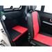 The image shows the interior of the Green Transporter Q Express Fully Enclosed Scooter, with black and red seats—one upright with a headrest and one flat bench—in its fully enclosed cabin. The door and window are also visible.