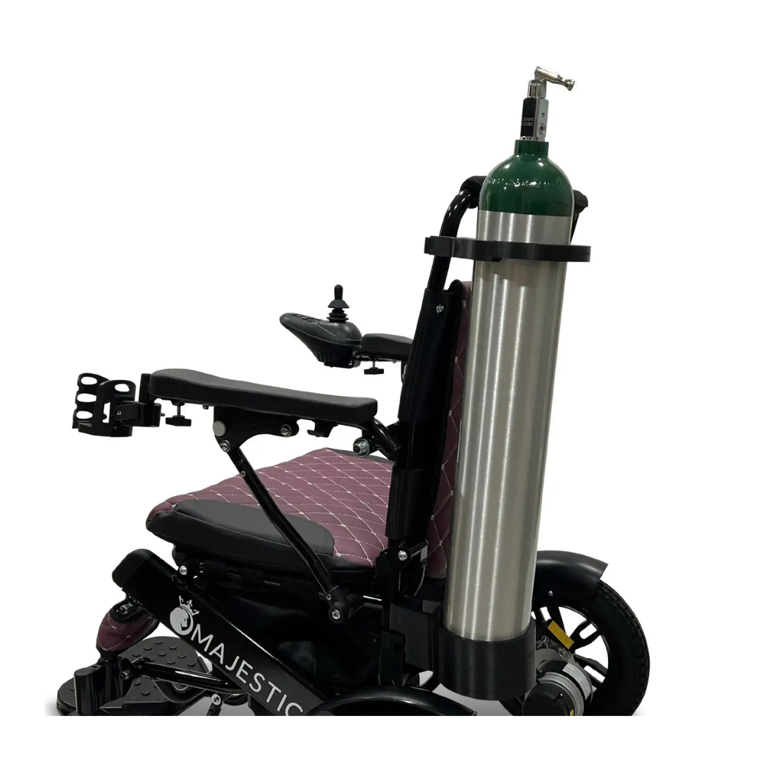 A black and purple electric wheelchair featuring the Quick Detach Oxygen E Tank Holder for ComfyGo Powerchairs, with a large oxygen tank mounted on the back.