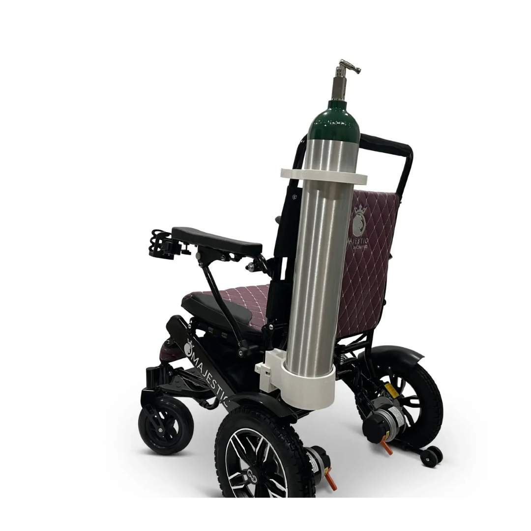 A ComfyGo powerchair with a quilted seat features the Quick Detach Oxygen E Tank Holder securing an oxygen tank upright at the back, set against a plain white background.