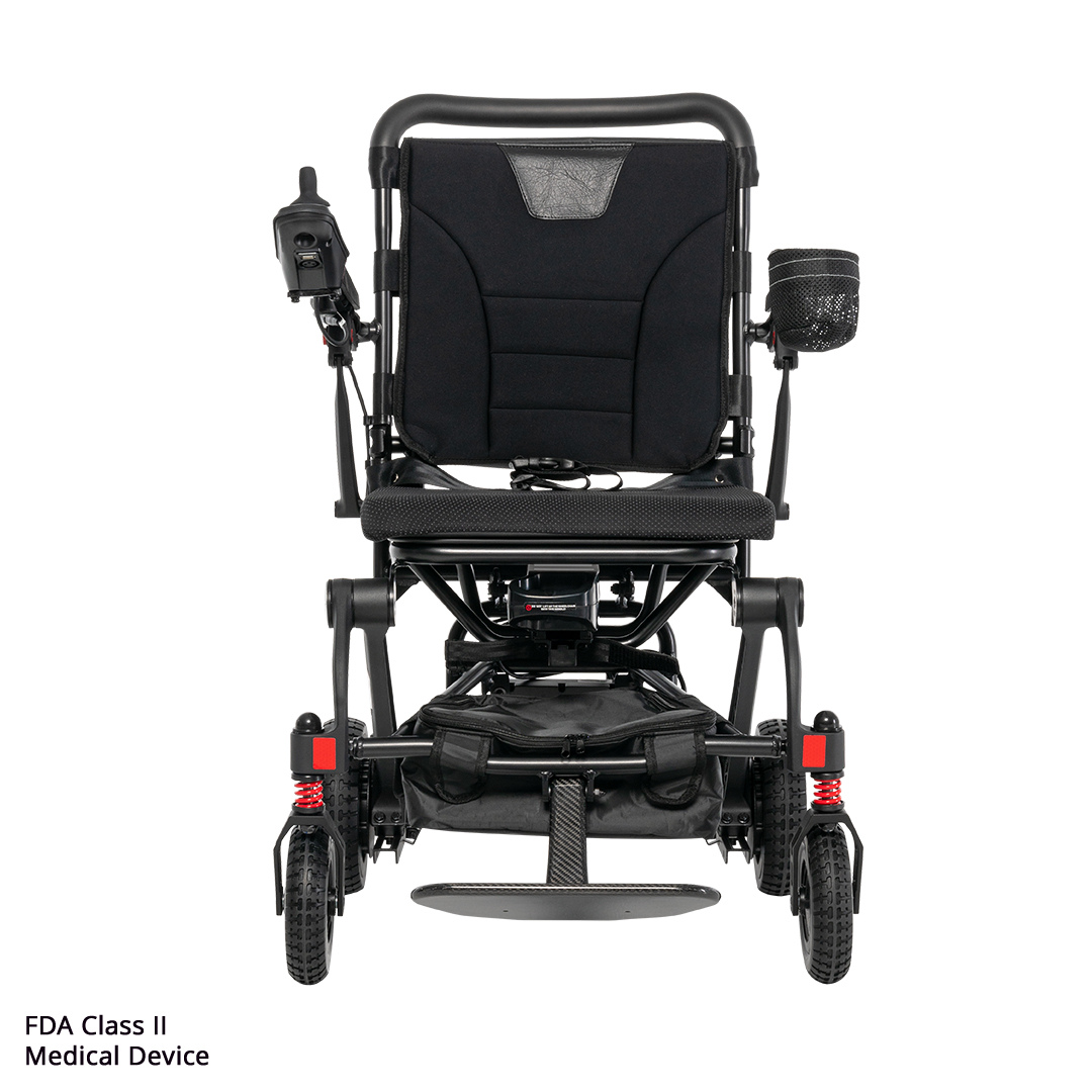 The Rascal® Carbon Cruiser Travel Folding Electric Wheelchair is a black, ultra-lightweight chair with left joystick control, armrests, mesh cup holder, sturdy front wheels, and FDA Class II Medical Device noted on the bottom left. Ideal for travel mobility.