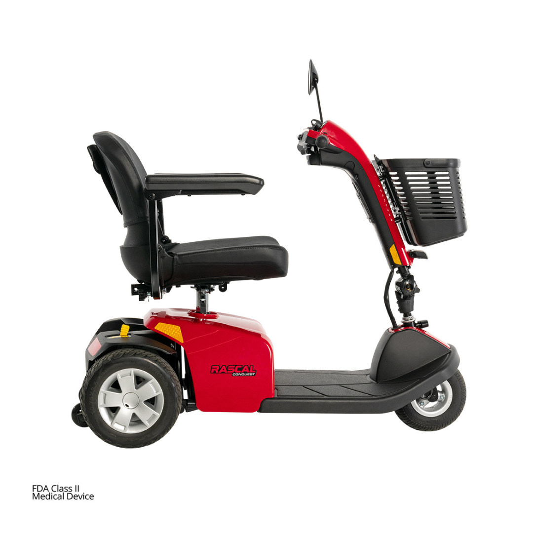 The Rascal® Conquest 3-Wheel Mobility Scooter features a red and black design, black seat with armrests, front basket, and large rear wheels—shown in side profile on a white background.