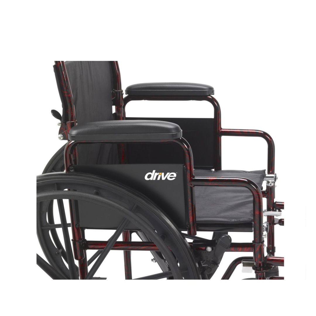 Side view of the Drive Rebel Wheelchair with Quick-Release Wheels in black and red, featuring armrests, large quick-release rear wheels, and part of the seat and backrest, with the “drive” logo visible against a white background.