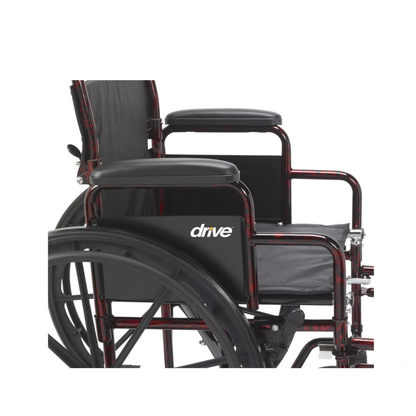 Side view of the Drive Rebel Wheelchair with Quick-Release Wheels in black and red, featuring armrests, large quick-release rear wheels, and part of the seat and backrest, with the “drive” logo visible against a white background.