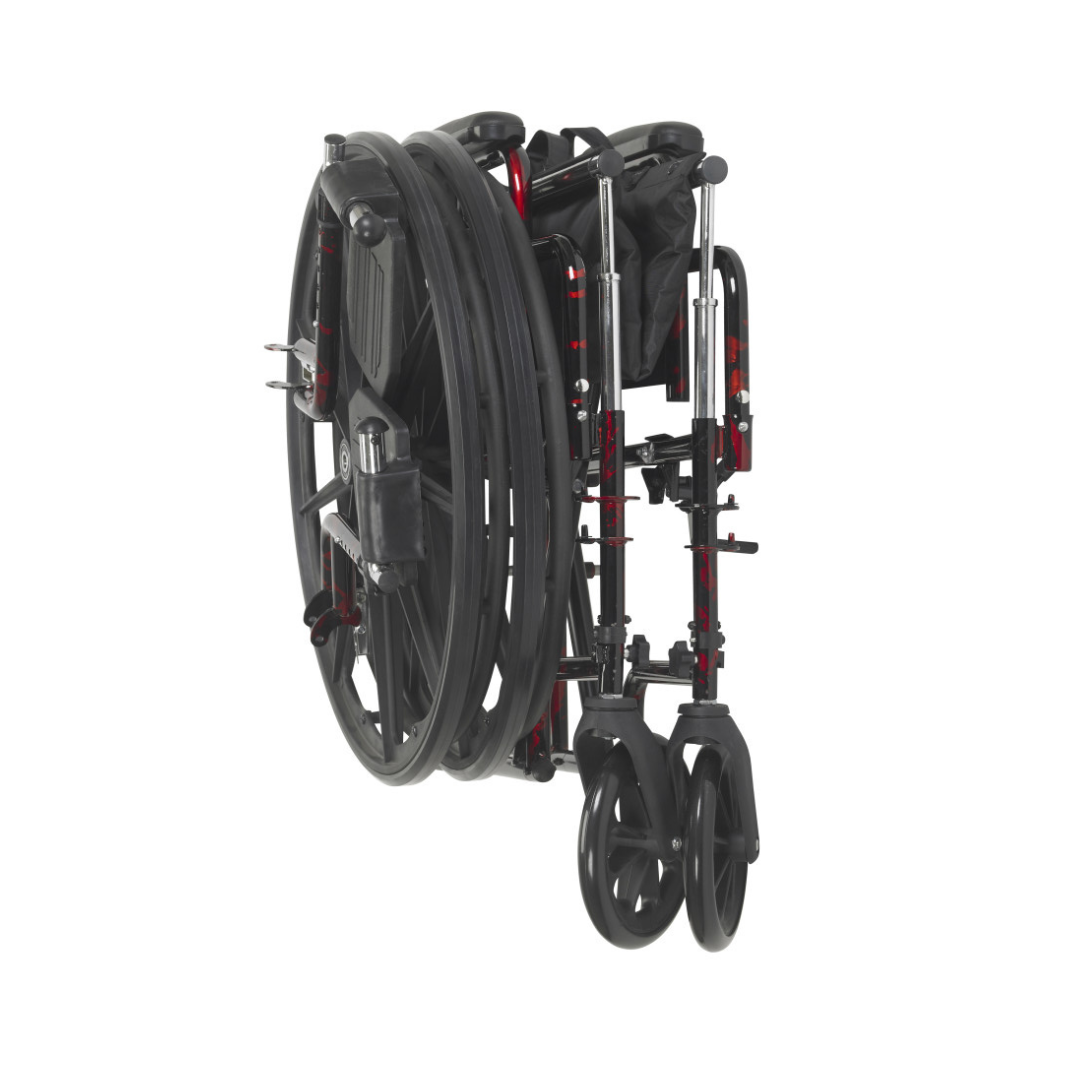 The Drive Rebel Wheelchair with Quick-Release Wheels in black and red is fully folded, showcasing its compact, space-saving design with wheels aligned closely and footrests tucked in.