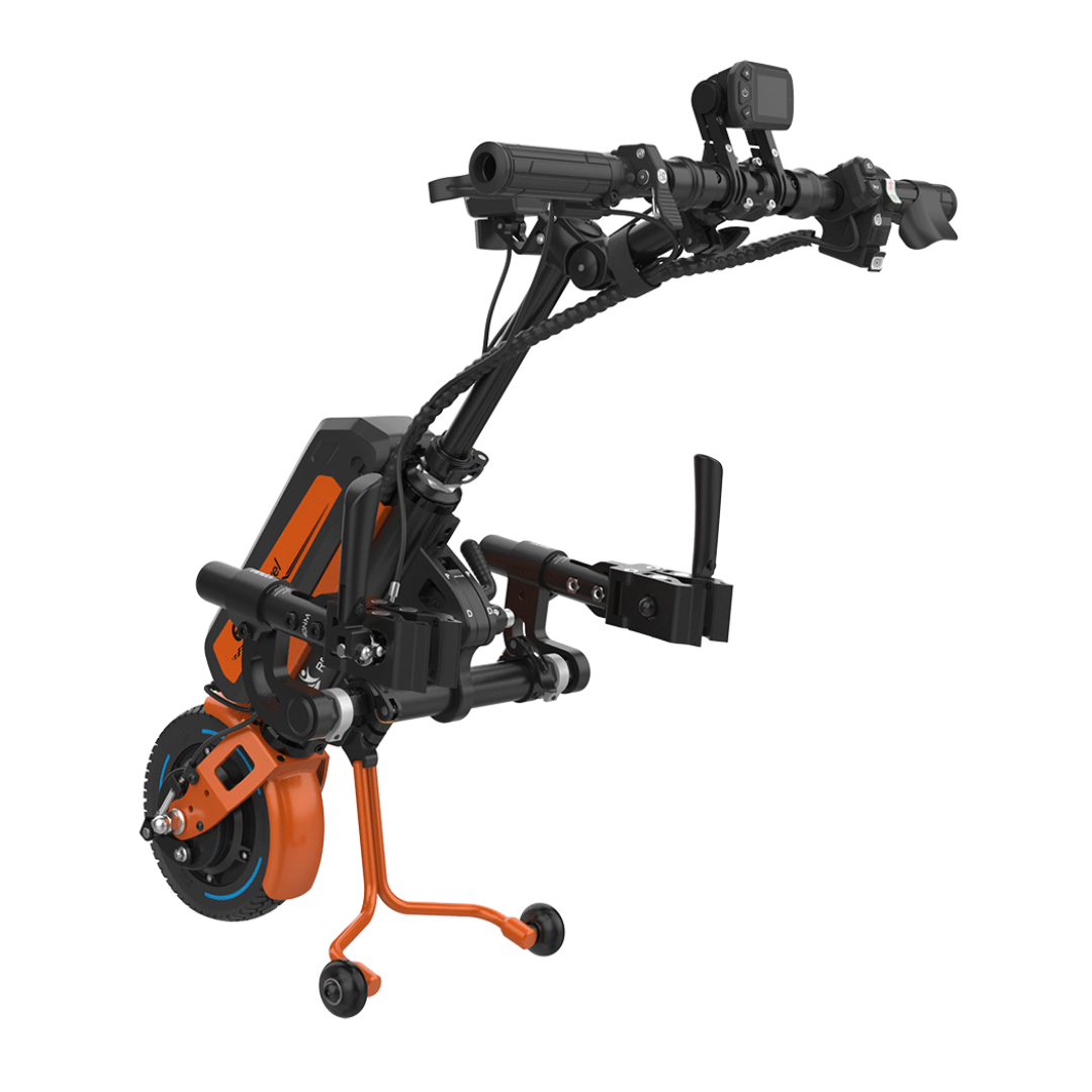 The Rehasense ECO Travel LX Power Add-On is a compact, lightweight black and orange electric motor assist with handlebars, front wheel, pedals, disc brake, and support legs, designed to connect to a manual wheelchair for enhanced mobility.