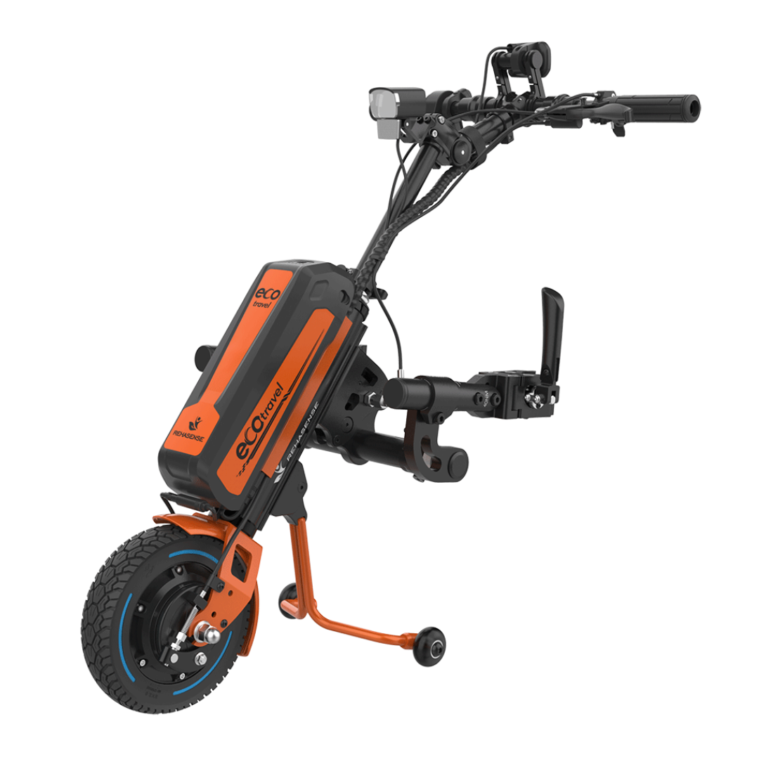 The Rehasense ECO Travel LX Power Add-On is a lightweight, orange and black motor assist for manual wheelchairs, featuring a single large front wheel, handlebars, display, and control panel.