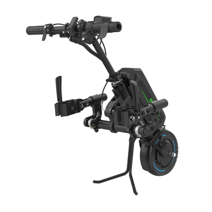 The Rehasense ECO Travel LX Power Add-On – Lightweight Wheelchair Motor Assist is a black and green device with handlebars, single front wheel, and kickstand, designed to mount to manual wheelchairs for improved mobility.