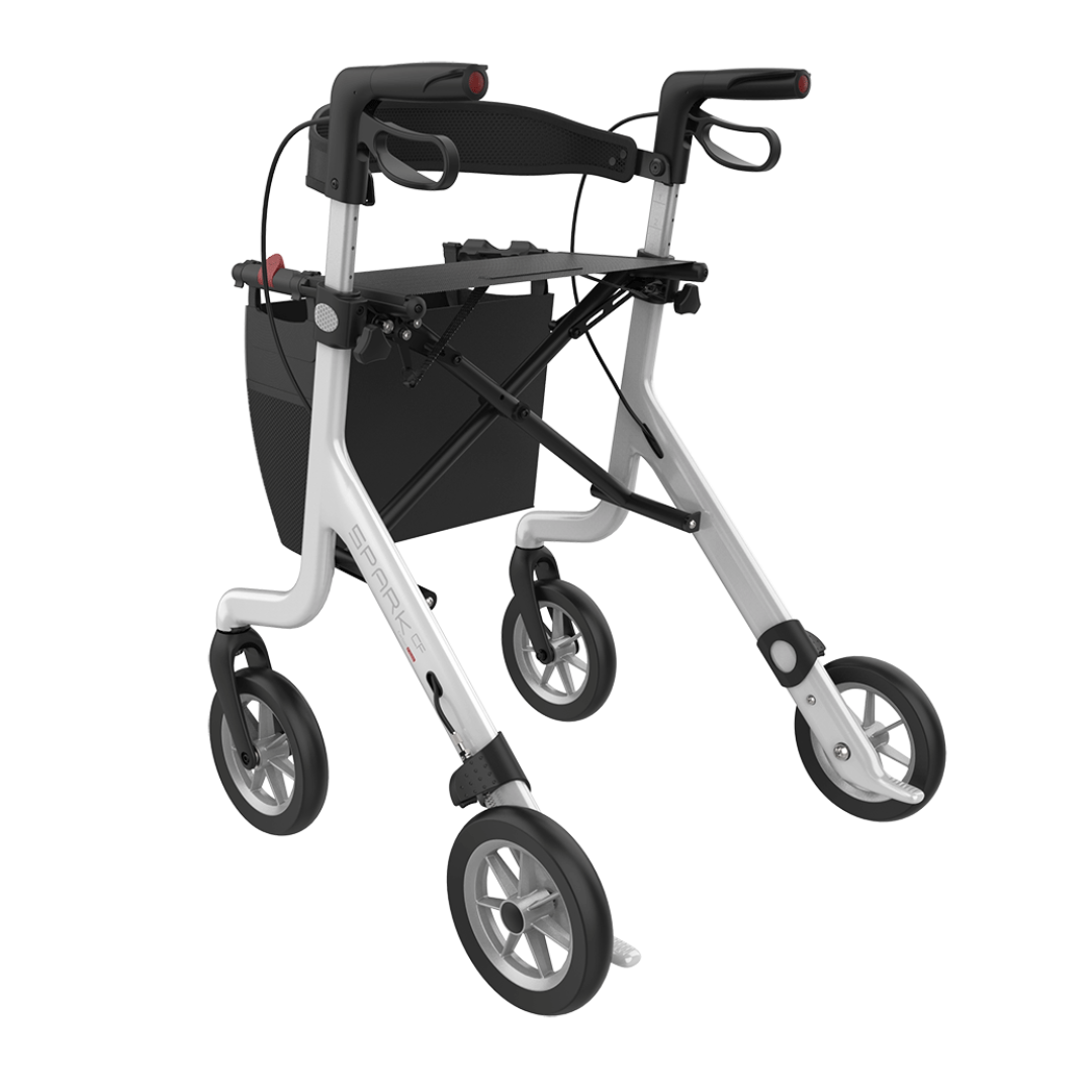 The Rehasense Spark CF Carbon Fiber Ultralight Rollator is a lightweight, foldable mobility aid with four large wheels, hand brakes, and a black pouch below the handles for convenient storage.