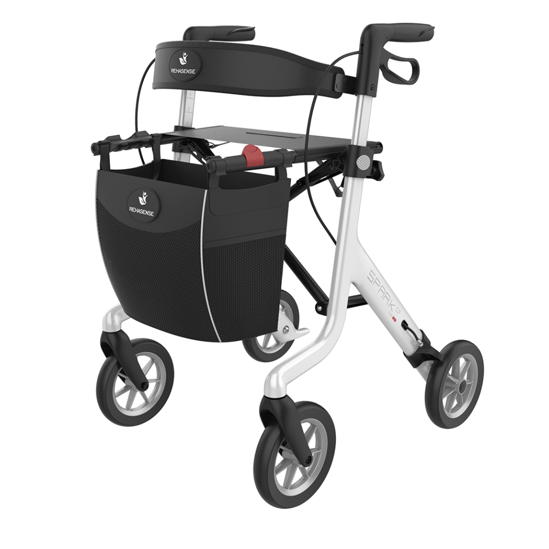 The Rehasense Spark CF Carbon Fiber Ultralight Rollator is a lightweight black and white mobility aid with four wheels, front storage bag, hand brakes, and a built-in seat for users needing walking assistance.