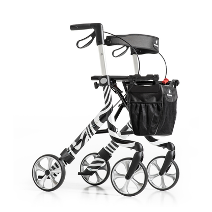 The Rehasense Space LX Art Deco Ultralight Rollator features four wheels, a zebra stripe design, black seat, hand brakes, and a front storage bag—offering stylish and functional mobility in a lightweight frame.