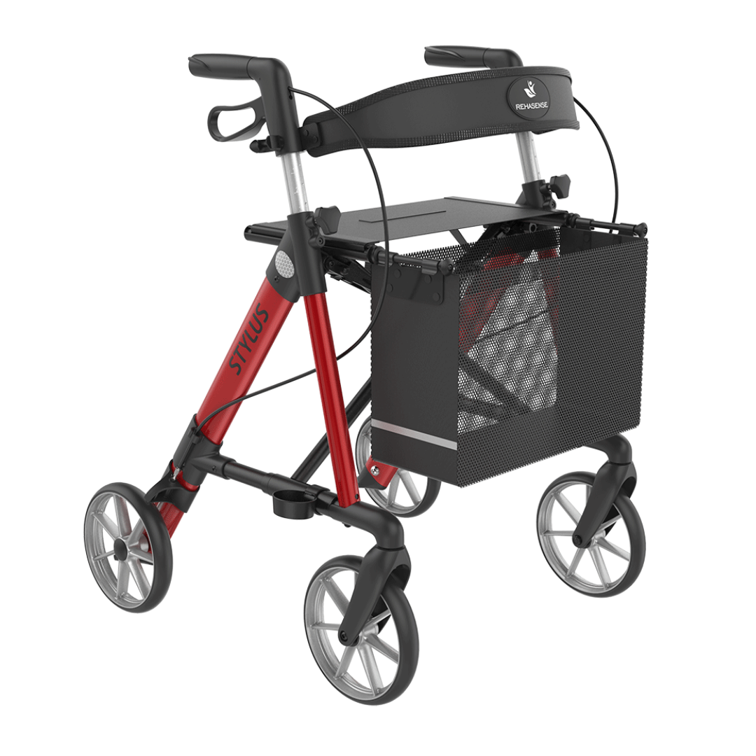 The Rehasense Stylus Premium Indoor & Outdoor Rollator is a red and black, large four-wheeled rollator with ergonomic handles, mesh storage basket, padded backrest, and "Stilus" branding on the frame—ideal for both indoor and outdoor use.