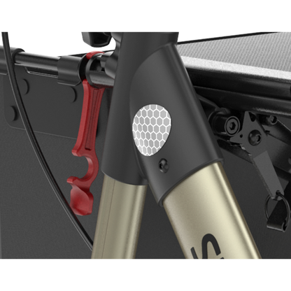 Close-up of a bicycle frame displaying a hexagonal reflector, red clip, cable, and part of a black cargo attachment—features similar to those on the Rehasense Stylus Premium Indoor & Outdoor Rollator.