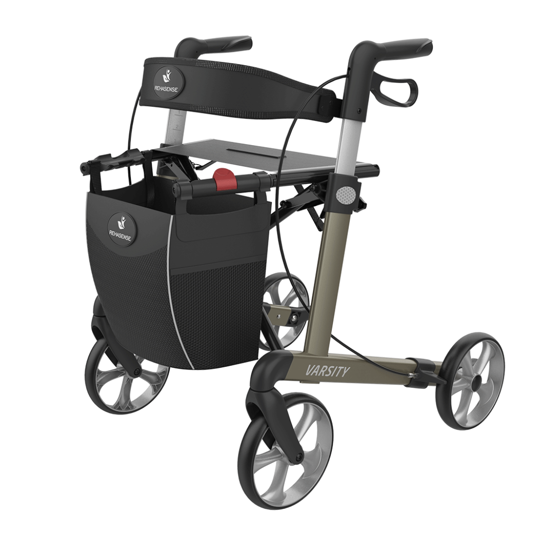 Experience reliable mobility with the Rehasense Varsity Folding Aluminum Rollator—featuring a sturdy metallic frame, ergonomic handles, four wheels, and a black storage bag.