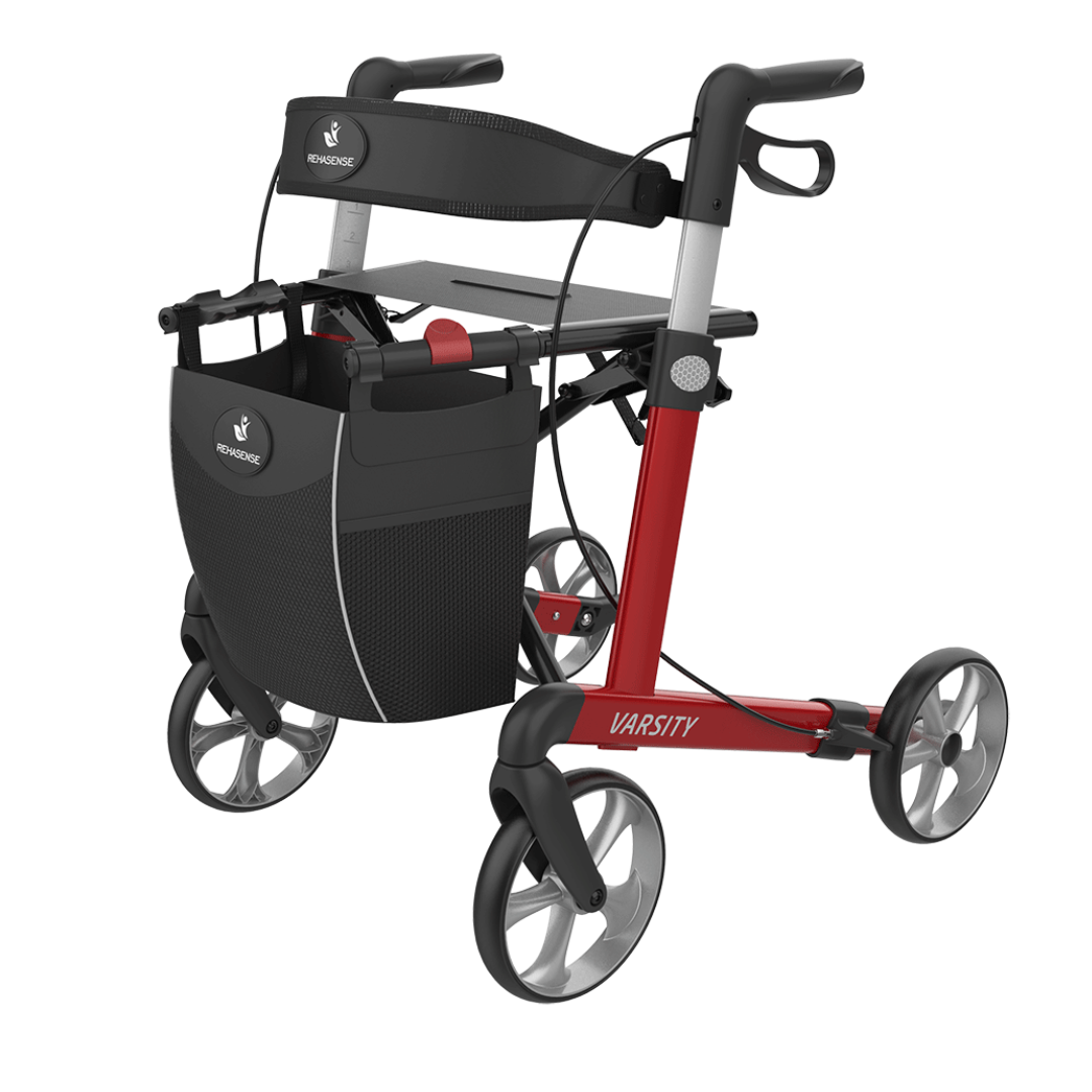 A red and black Rehasense Varsity Folding Aluminum Rollator with a seat, hand brakes, and a front storage bag. The product features lightweight aluminum construction with the model name "Varsity" visible on the frame.